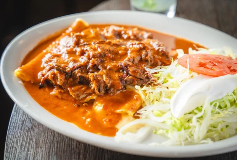 Enchiladas smothered in house sauce at El Jinete